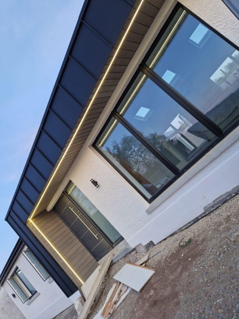 Job done in Ballybofey, Donegal - front porch at the front wrapped with black elzinc aluminium standing seam panels and a private bar at the rear again wrapped with black elzinc aluminium standing seam panels.