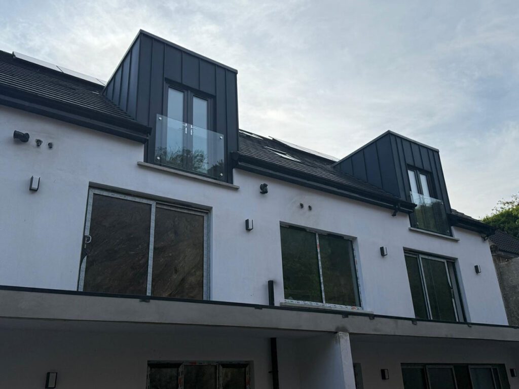 Strata waterproofing PVC single ply on 4 dormers tops and a rear balcony. Dormers then wrapped with Prefa anthracite aluminium standing seam cladding.