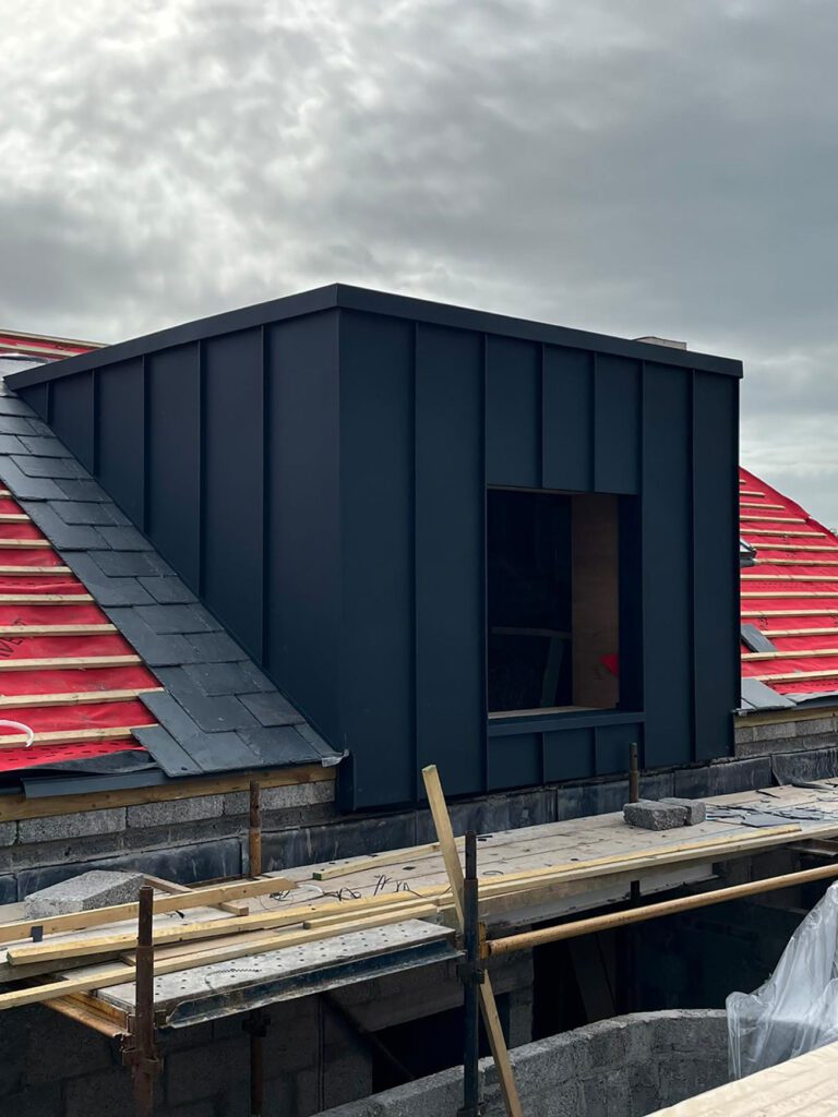 Dormer done with Strata waterproofing PVC single ply top and then surrounded with Prefa anthracite aluminium standing seam cladding