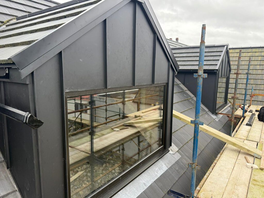 Dormers done with Black elzinc aluminium standing seam panels and a Strata waterproofing PVC single ply balcony